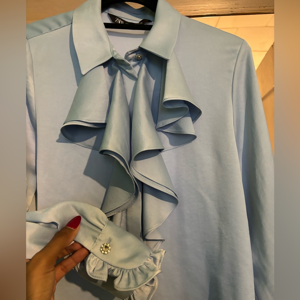 Blue ruffle button up top.